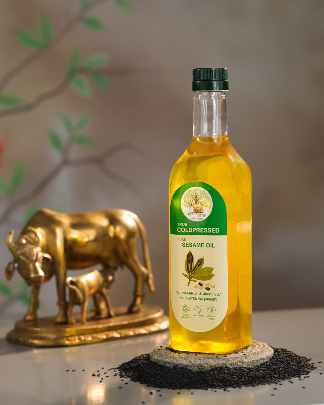 Bottle of sesame oil with a decorative bull statue in the background